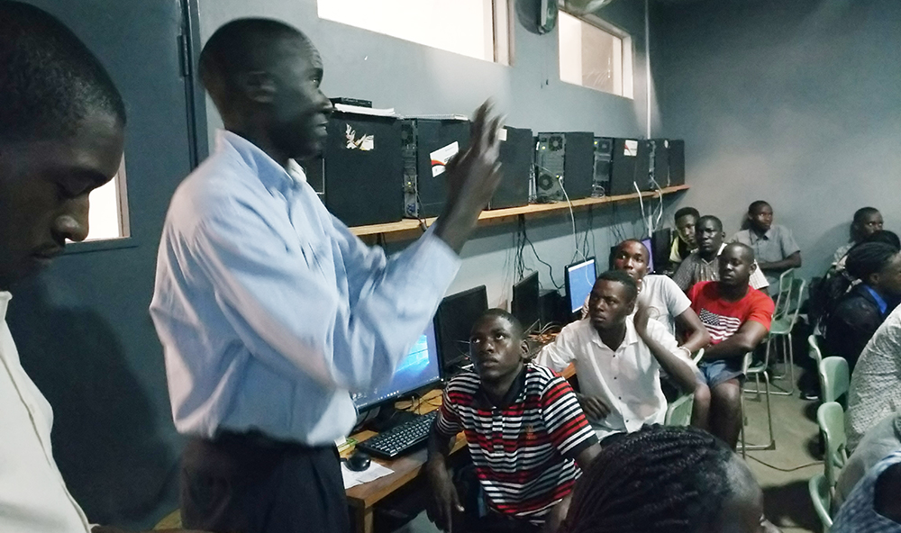 Barry, a sign language interpreter translating for the young deaf persons in the training